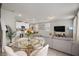 Spacious living area with a dining table, a sofa, and a view to the kitchen at 2052 Milkweed St, Ocoee, FL 34761