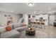Open-concept living area with a modern kitchen, a gray sofa, and a dining area at 2052 Milkweed St, Ocoee, FL 34761