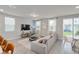 Open-concept living room with tile flooring and neutral tones offers a relaxing atmosphere at 2052 Milkweed St, Ocoee, FL 34761
