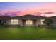 Backyard featuring a manicured lawn, covered patio, and well-maintained landscaping, perfect for relaxation at 2282 Kaley Ridge Rd, Clermont, FL 34715