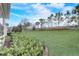 Sprawling backyard showcases an expansive lawn, mature trees, and manicured landscaping at 2282 Kaley Ridge Rd, Clermont, FL 34715