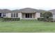 Well-maintained backyard featuring a lush lawn and a covered patio accessible through sliding glass doors at 2282 Kaley Ridge Rd, Clermont, FL 34715