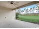 Covered patio boasts backyard view with a green lawn and landscaped border with trees at 2282 Kaley Ridge Rd, Clermont, FL 34715