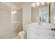 Bathroom featuring a glass-enclosed shower and single sink vanity with bright vanity lighting at 2282 Kaley Ridge Rd, Clermont, FL 34715