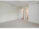 Bedroom with carpet and a closet with sliding doors and an attached bathroom at 2282 Kaley Ridge Rd, Clermont, FL 34715
