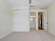Bedroom with carpet, a ceiling fan, a closet with sliding doors, and an attached bathroom at 2282 Kaley Ridge Rd, Clermont, FL 34715