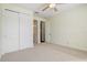 Bedroom with carpet, a ceiling fan, and a closet with sliding doors at 2282 Kaley Ridge Rd, Clermont, FL 34715