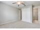 Neutral bedroom features carpeted floors, a ceiling fan, a closet, and an attached bathroom at 2282 Kaley Ridge Rd, Clermont, FL 34715