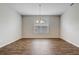 Empty dining room features hard floors, a large window with blinds, and an elegant light fixture at 2282 Kaley Ridge Rd, Clermont, FL 34715