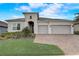Charming home showcasing a three-car garage, a beautifully landscaped yard, and a striking front facade at 2282 Kaley Ridge Rd, Clermont, FL 34715