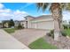 Well-manicured front yard with paver driveway, three-car garage, and beautiful landscaping at 2282 Kaley Ridge Rd, Clermont, FL 34715