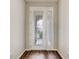 Elegant front door with decorative glass inserts, set against a backdrop of wood-look floors at 2282 Kaley Ridge Rd, Clermont, FL 34715