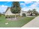 Well-maintained front yard with a neatly trimmed lawn, mature tree, and manicured landscaping showcasing the property's curb appeal at 2282 Kaley Ridge Rd, Clermont, FL 34715