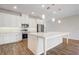 Modern kitchen features stainless steel appliances, center island, pendant lights, and white cabinetry at 2282 Kaley Ridge Rd, Clermont, FL 34715