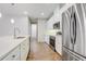 Well-lit kitchen boasts stainless steel appliances, white cabinets, and a clean, contemporary design at 2282 Kaley Ridge Rd, Clermont, FL 34715