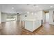 Bright, modern kitchen features an island with pendant lights and a seamless flow into the adjacent living area at 2282 Kaley Ridge Rd, Clermont, FL 34715