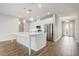 Bright kitchen with stainless steel appliances, center island, pendant lights, and wood-look tile flooring at 2282 Kaley Ridge Rd, Clermont, FL 34715
