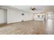 Open-concept living space with wood-look tile floors connecting to a modern kitchen with a breakfast bar at 2282 Kaley Ridge Rd, Clermont, FL 34715