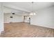 Open-concept living room with wood-look tile, ceiling fan, and views to kitchen and dining areas at 2282 Kaley Ridge Rd, Clermont, FL 34715