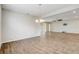 Spacious living room with wood-look tile, chandelier, ceiling fan, and sliding glass doors at 2282 Kaley Ridge Rd, Clermont, FL 34715