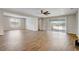 Spacious living room with wood-look tile flooring, ceiling fan, and sliding glass doors to the outside at 2282 Kaley Ridge Rd, Clermont, FL 34715