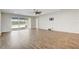 Living room featuring wood-look tile flooring, ceiling fan, and sliding glass doors to the outside at 2282 Kaley Ridge Rd, Clermont, FL 34715