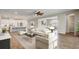 Bright living room open to a modern kitchen and dining area, with neutral decor and wood-look flooring at 2282 Kaley Ridge Rd, Clermont, FL 34715