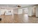 Open concept living area featuring wood-look tile floors, a modern kitchen with a breakfast bar, and spacious layout at 2282 Kaley Ridge Rd, Clermont, FL 34715