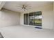 Covered patio with concrete flooring, neutral walls, and view of the backyard through sliding doors at 2282 Kaley Ridge Rd, Clermont, FL 34715