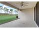 Covered patio view includes the backyard's lush green lawn with decorative borders and a tree line at 2282 Kaley Ridge Rd, Clermont, FL 34715