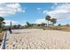 Sandy outdoor volleyball court with net, offering recreational opportunities amidst a sunny, landscaped setting at 2282 Kaley Ridge Rd, Clermont, FL 34715