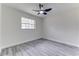 Bedroom featuring gray wood-look flooring, a large window, and neutral paint at 2341 Sw 11Th Ave, Ocala, FL 34471