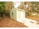 Close up of a backyard storage shed, with green siding and white trim and door at 2341 Sw 11Th Ave, Ocala, FL 34471