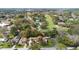 Aerial view of a residential area, showcasing homes, streets, and a golf course nestled among the trees at 26 Backspin Ln, Orlando, FL 32804