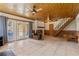 Finished basement with wood ceiling, brick fireplace, and access to the backyard at 26 Backspin Ln, Orlando, FL 32804