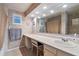 Bathroom features a long vanity, built-in seating, and decorative mirror with accent lighting at 26 Backspin Ln, Orlando, FL 32804