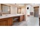Bathroom features a double vanity with seating, ample lighting, and a separate shower and tub at 26 Backspin Ln, Orlando, FL 32804