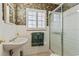 Well-lit bathroom with a white vanity, updated shower, and floral wallpaper design at 26 Backspin Ln, Orlando, FL 32804