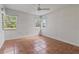 Simple bedroom features tile flooring and ample natural light with several windows at 26 Backspin Ln, Orlando, FL 32804