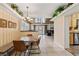 Bright dining area with striped walls, modern lighting, and a view to the backyard at 26 Backspin Ln, Orlando, FL 32804