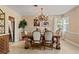 Cozy dining room featuring a large wooden table, chandelier lighting and easy access to the kitchen at 26 Backspin Ln, Orlando, FL 32804