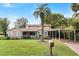 Inviting home with a mature palm tree and a covered carport adding to the property's appeal at 26 Backspin Ln, Orlando, FL 32804