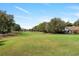 A beautiful, lush green golf course bordering a house, offering a serene and picturesque view at 26 Backspin Ln, Orlando, FL 32804
