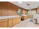 Vintage kitchen featuring wood paneling and cabinetry, along with ample counter space at 26 Backspin Ln, Orlando, FL 32804