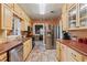 Charming kitchen with stainless steel appliances, light wood cabinets, and tiled floors at 26 Backspin Ln, Orlando, FL 32804