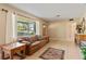 Inviting living room with tile floors, a cozy leather sofa, and lots of natural light at 26 Backspin Ln, Orlando, FL 32804