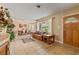 Bright living room featuring tile floors, large windows, and an open dining area at 26 Backspin Ln, Orlando, FL 32804