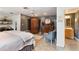 A well-lit main bedroom with a large bed, ceiling fan, seating area, and access to the en suite bath at 26 Backspin Ln, Orlando, FL 32804