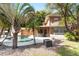 Backyard pool with a screened-in porch, tropical landscaping, and lush lawn at 26 Backspin Ln, Orlando, FL 32804