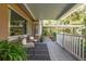 Relaxing covered porch featuring brick flooring, comfortable seating, and a tranquil outdoor view at 26 Backspin Ln, Orlando, FL 32804